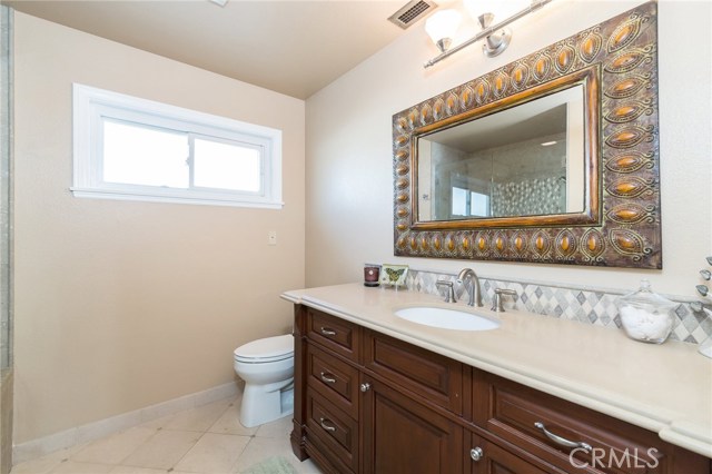 Master Bathroom– Dark Adler Cabinets, Travertine Floors, Heated Exhaust Fan and Brushed Nickel Fixtures Master Bathroom– Dark Adler Cabinets, Travertine Floors, Heated Exhaust Fan and Brushed Nickel Fixtures