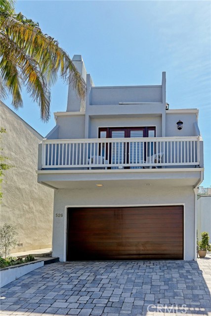 Front exterior with newly installed gutters and new Mesa garage door.