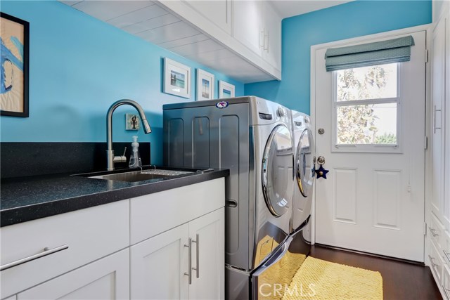 A happy laundry room with oodles of storage!