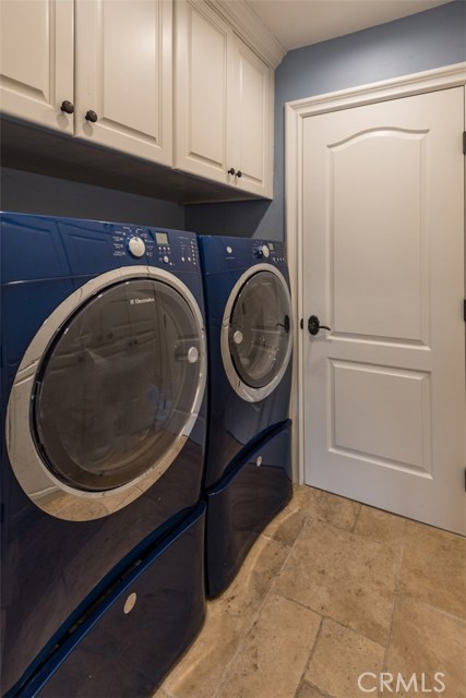 Laundry room adjacent to garage access and office.