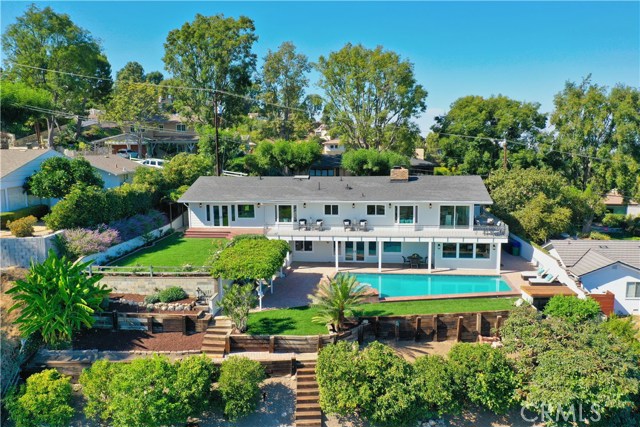 Drone footage of backyard, pool and orchard