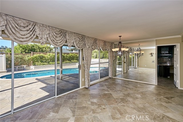 Dining area with wall to wall glass windows and sliding door.