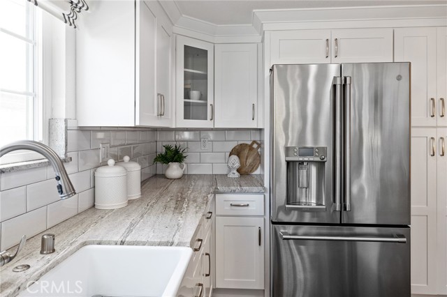 This kitchen also features granite countertops and a GE Café appliance package.