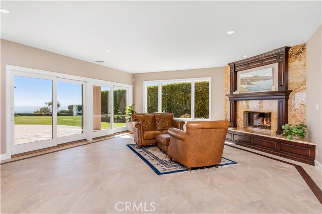 Lower level sitting area with fireplace and pool/ocean views