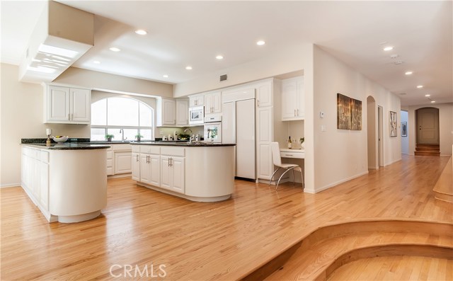 Maple hardwood flooring.  Kitchen with central island.