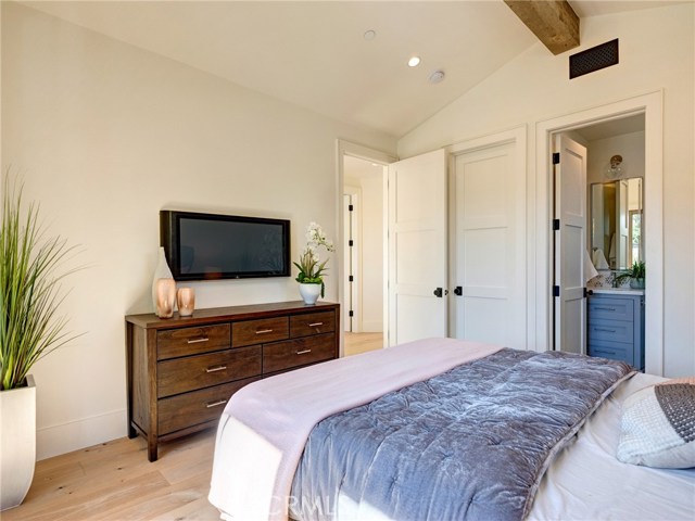 Upstairs bedroom suite with Juliet balcony, Trestlewood accent wood beam, whole home surround sound, and en-suite bathroom.