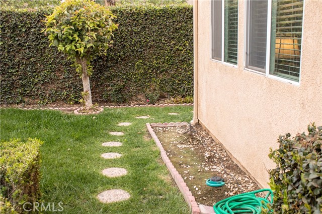 Walkway to south side of house from backyard.