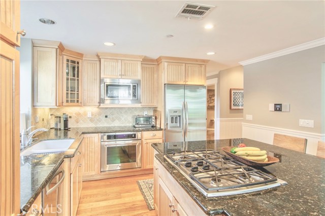 large kitchen island with vent that disappears at the touch of a button helps keep the look clean, neat and open