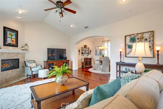 Bright open living room with beautiful cherry wood floors, recessed lights, gas fireplace, ceiling fan.  Attached large and private balcony off the living room.