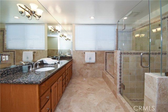 Remodeled master bath features double vanity sinks, step down tub and separate shower.