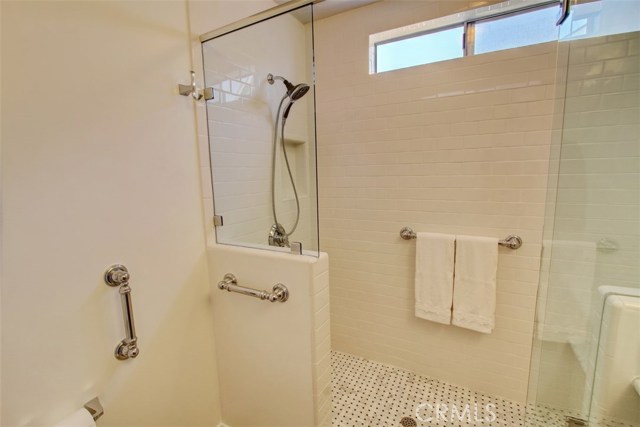 Walk-in shower with basket weave Mosaic Carrara marble floor