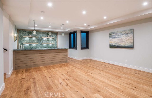 Amazing Finished Basement! 625 Square Feet- Can qualify as Bedroom #6. 
Leather Finish Custom Granite Countertops. Built In Refrigerator, Dishwasher and Sink with unique water tap. Beautiful Custom Glass Tile Backsplash, Framed. Floating Custom Shelving with Built In Under Shelf Lighting. Ample Cabinet and Storage Space. High Quality Lighting Fixtures with Dimmer Controls.
