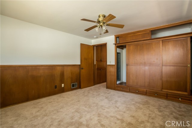 The 3rd bedroom at which is located at the front of the house is large with a full wooden wall closet and wood wainscoting.