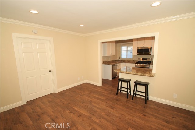 Front house living room looking toward kitchen.  Gorgeous flooring, all new moldings, smooth ceilings, recessed lighting, etc!