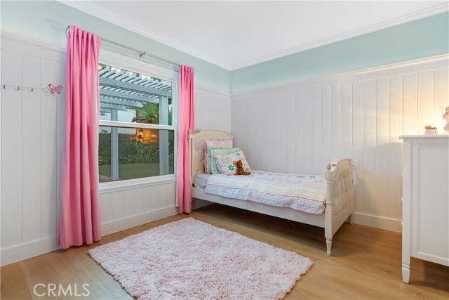 Bedroom #2 - With a view into the backyard, custom wainscoting, Emtek oil rubbed bronze hinges and door knobs, lighting by Rejuvenation, Wide plank French oak flooring, Lutron dimmer light switches.