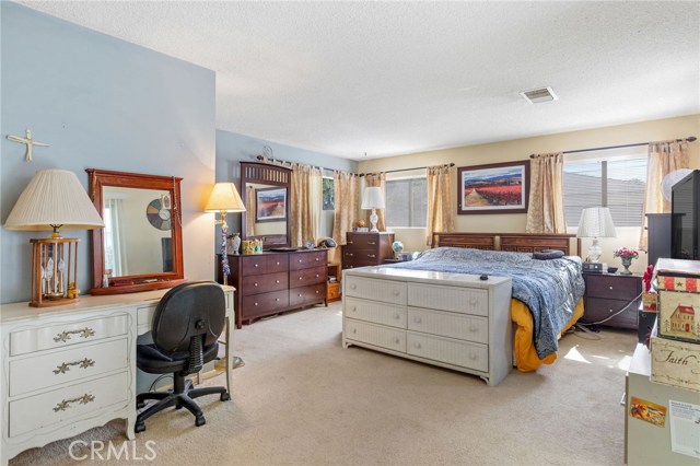 !st level en-suite bedroom. 2 closets and lots of natural light. Sliding door opens to patio and yard (right side of room).