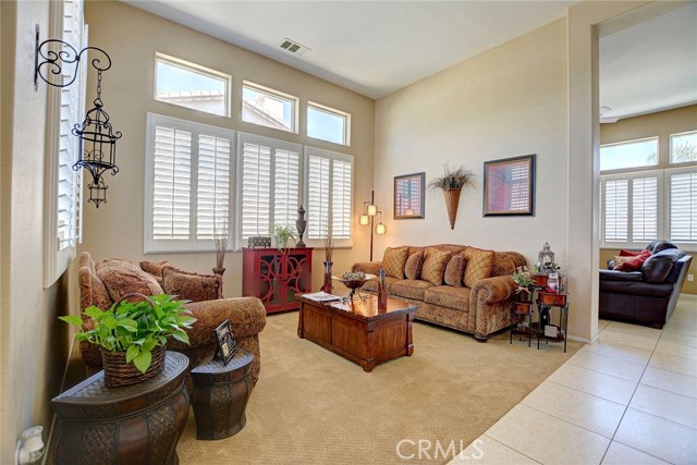 Spacious formal living room, plantation shutters.