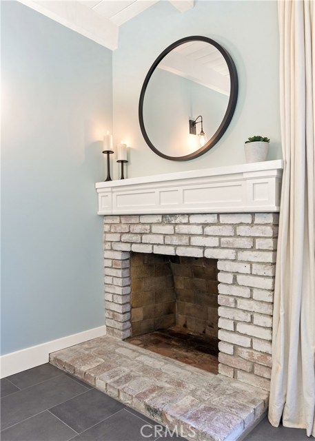 The primary bedroom suite's wood burning fireplace with custom mantle is the perfect touch to this retreat.
