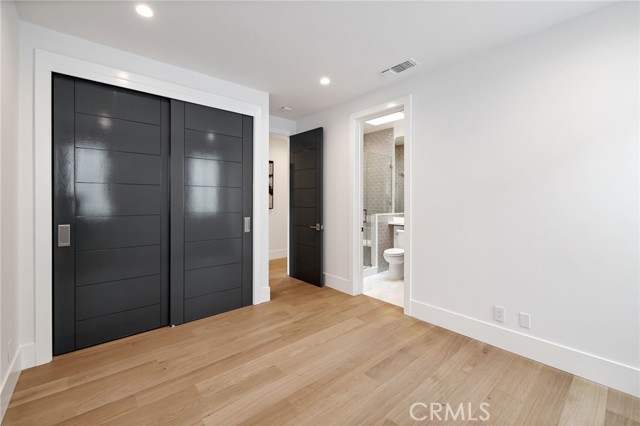 Spacious bedroom with private bath and designer closet doors