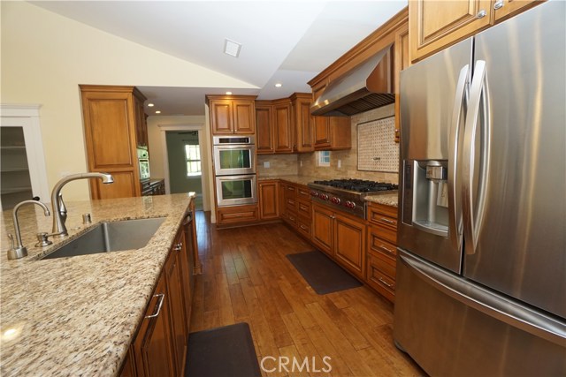 Gorgeous kitchen with all amenities. two ovens, stainless appliances, 8 burner stove top, and a pot filler faucet over oven, & more.