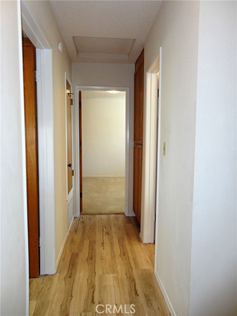 upstairs hallway with linen closet leading to master bedroom & bathroom