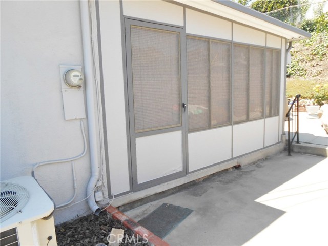 Exterior View of Greatly Maintained Enclosed Patio Door, Windows and Siding.