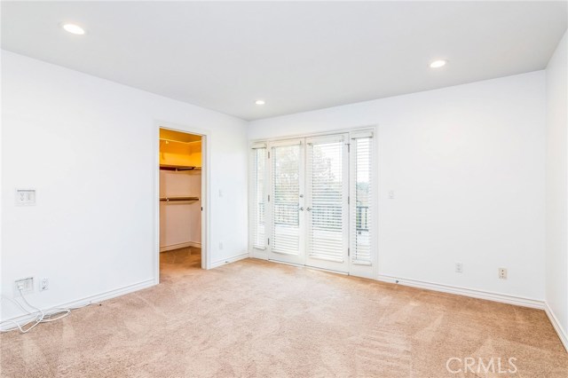 Bedroom #4, French doors leading to balcony, walk-in closet
