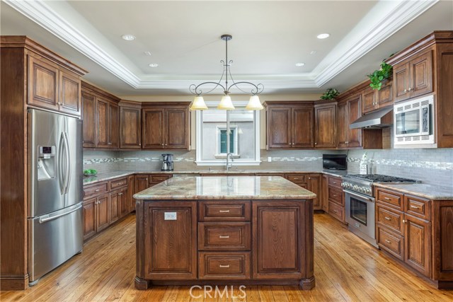 Exquisite Fire Bordeaux 6' Granite Island and Counters. Custom Hickory cabinets with hidden, under cabinet lighting and electrical.