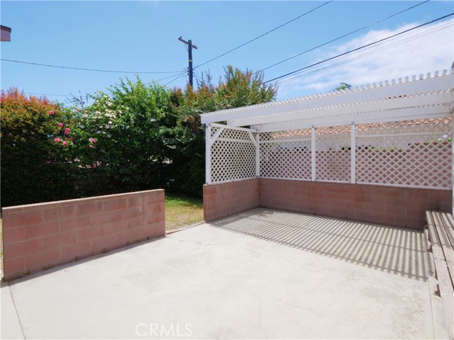 Large backyard patio leads to yard on the left.