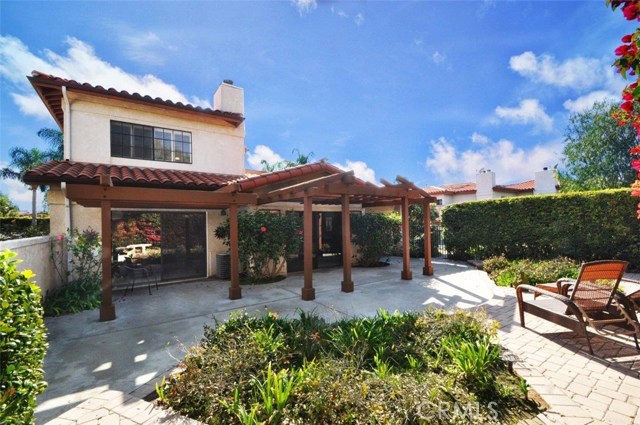 Another view of rear yard showing pavers, patio and wood detail