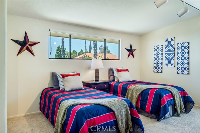 4th bedroom with vaulted ceiling and track lighting