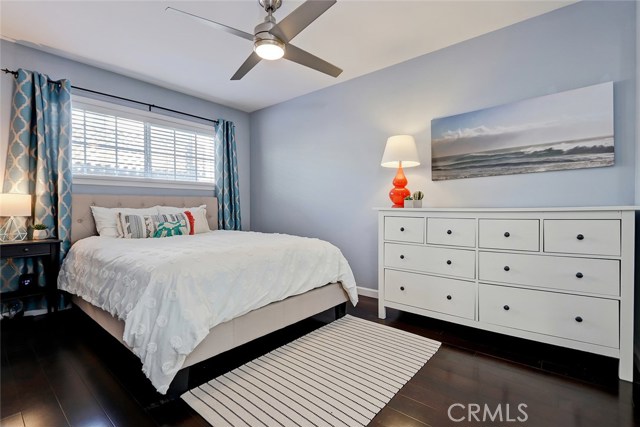 Master bedroom with mirrored closet doors.