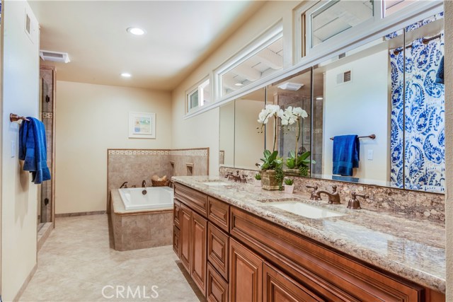 Over-sized newly remodeled master baths features heated floors, spa size tub, separate shower, 2 sink vanity and walk-in closet