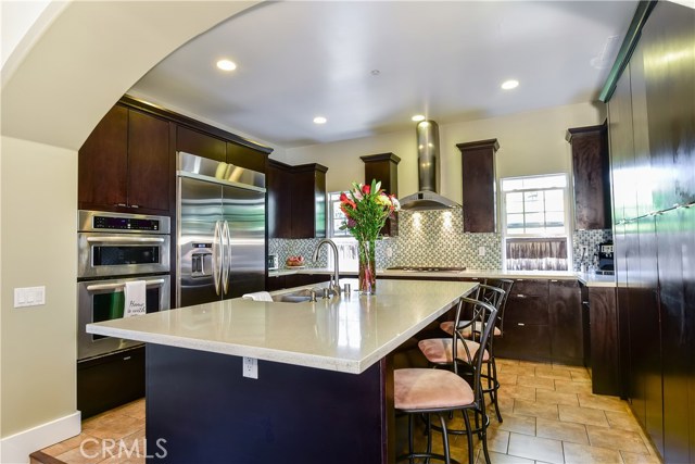 Fabulous kitchen! Built-in Kitchen Aid appliances including a 5 burner cooktop. Large center island with room for at least 6 stools for casual dining.