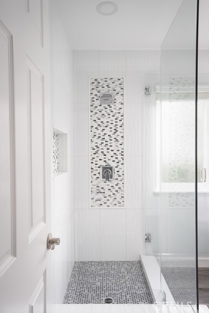 Walk in master shower with beautiful tile