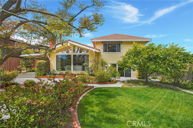 Large park-like backyard with mature trees and rose gardens
