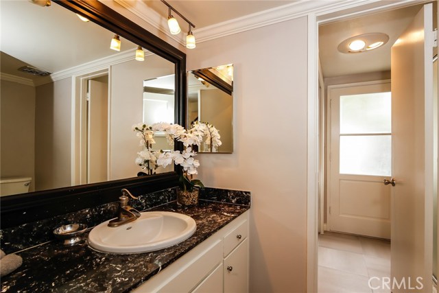 The picture perfect guest bathroom with the adjacent laundry room