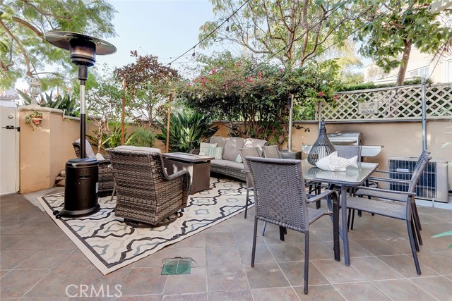 Lush trees and greenery gives this enclosed front patio great privacy.