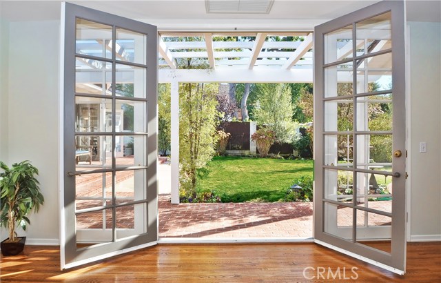 French Doors from Beautifully Landscaped Backyard Leads to Master Suite