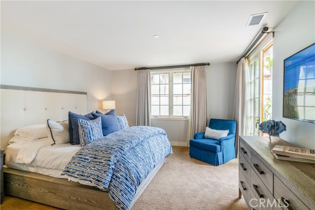 Light and bright, the third bedroom features doors to private courtyard.