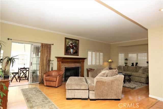 Living room, 9' ceilings, hardwood flooring and plantation shutters.  Access to side patio through sliding glass doors.  Short trip from your outdoor BBQ to the dining room!