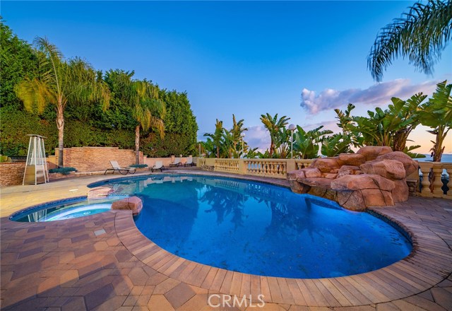 Imagine cooling down and enjoying the ocean views from this phenomenal backyard with inviting pool, jetted spa, waterfalls, built in bar-b-que, covered patio with flat screen television. Ahhh, life is good on Cartier!