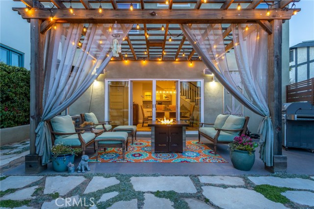 Patio lounge area with lighted pergola.