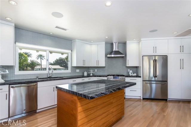 The Black Sea Serpentine stone counters and island is a cool and subtle feature to the kitchen.