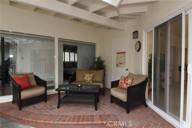 Pretty covered sitting area!  Door to extra ½ bath is to the left of the clock.