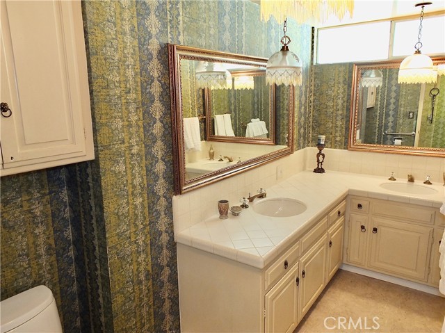 The bath off the hallway is elegant and spacious with double sinks!