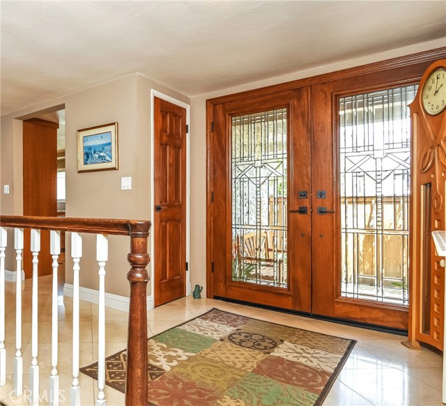 The leaded glass doors open onto the large entry with travertine floors that run through the kitchen and dining area.