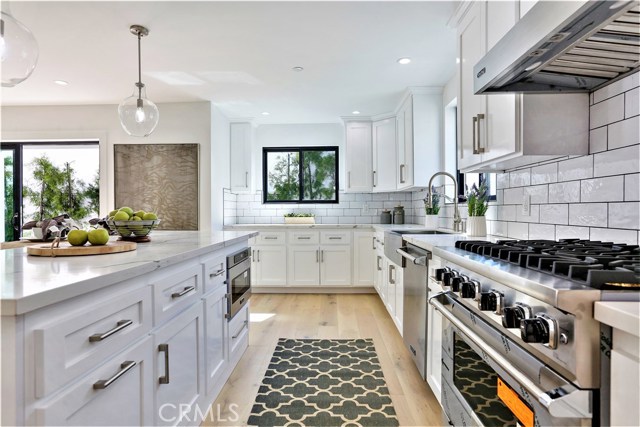 The Kitchen Features, Top Quality Viking Stainless Steel Appliances, Stainless Farmhouse Sink, Porcelain Subway Tile Backsplash Walls and Thick Slab Carrara Caesarstone counter surfaces