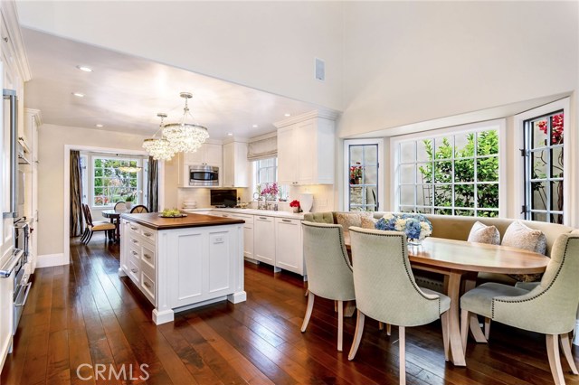 Another view of dining room, kitchen and corner banquette.