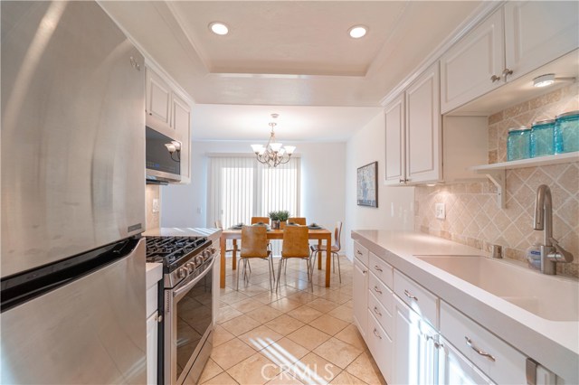 Kitchen view into Dining area and Patio